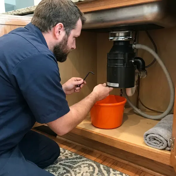 BKN Plumbing technician providing garbage disposal repair in Portland, ME